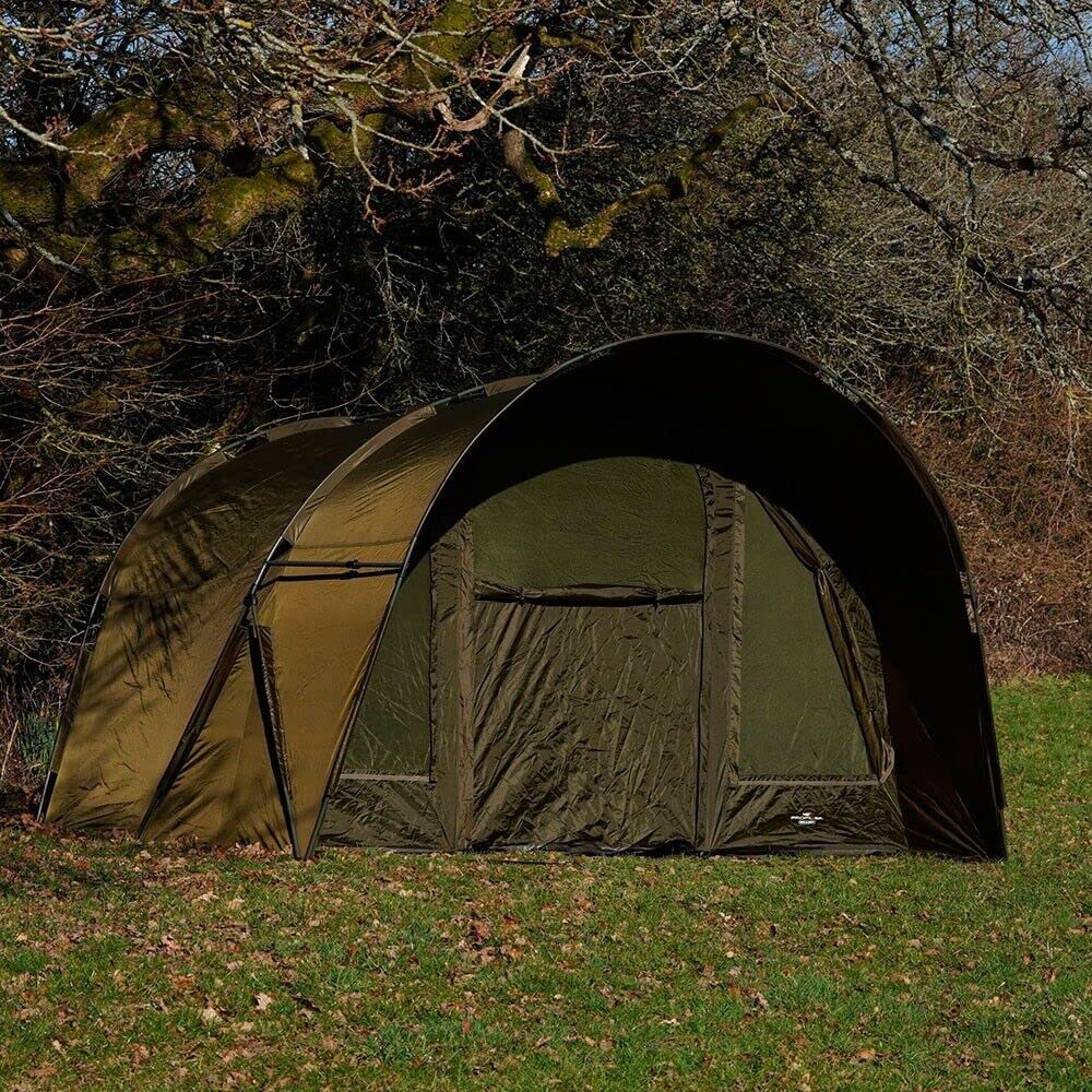 A large domed carp fishing bivvy pitched on the bank at dawn